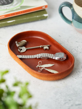 "Beautifully hand-dyed leather catchall trays in a variety of colours and shapes, ideal for keeping small items like keys, cufflinks, or sunglasses neatly stored. A perfect gift for him or her.