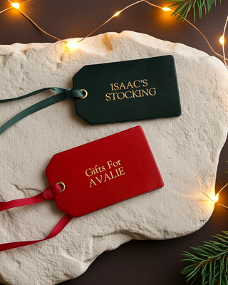 Christmas Gift Labels in green and red, personalised with 'Gifts for Avalie' and 'Isaac's Stocking'