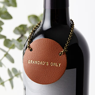 Premium tan leather bottle tag with gold embossed text reading 'Grandad’s Only', attached with an antique-style brass chain. A unique personalised gift for wine and whisky lovers