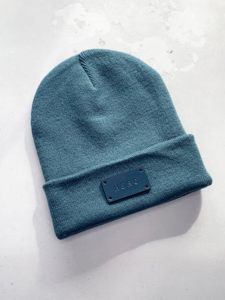 Hero text on dark teal beanie hat.