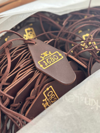 Case Study: Bespoke Leather Cloakroom Tags for Tigers Eye