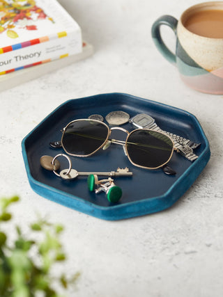 Dark blue leather catchall tray in a octagon shape.