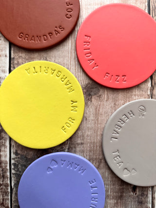 leather coasters in a bright yellow lime with 'for my margarita' stamped around the edge.