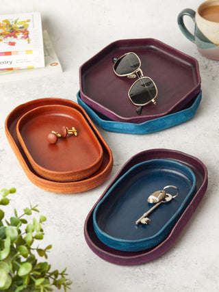 Handcrafted leather valet trays in rich tones of tan, navy, and burgundy, perfect for organising keys, jewellery, and everyday essentials. Stylish and practical home accessories.