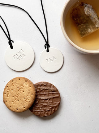 Minimalist white leather pantry tags with hand-stamped labels for kitchen storage. Rustic and stylish labels with black cord, ideal for home organisation and pantry décor